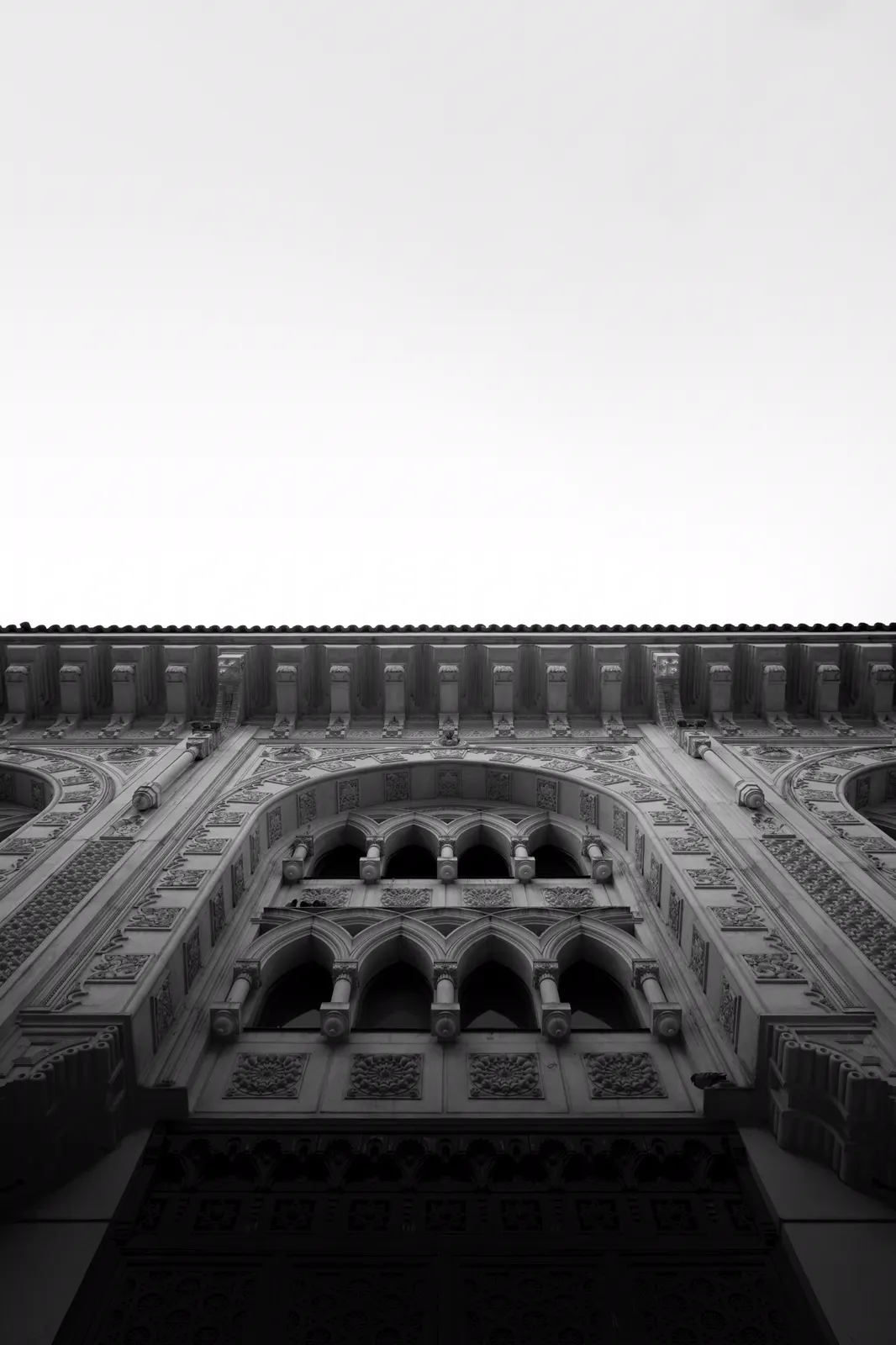 Richly carved mosque façade with arched windows